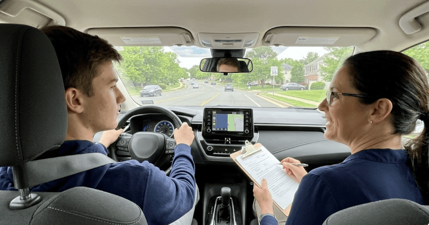 Instructor guiding a young adult student during behind the wheel training for Virginia drivers ed for 18 year olds